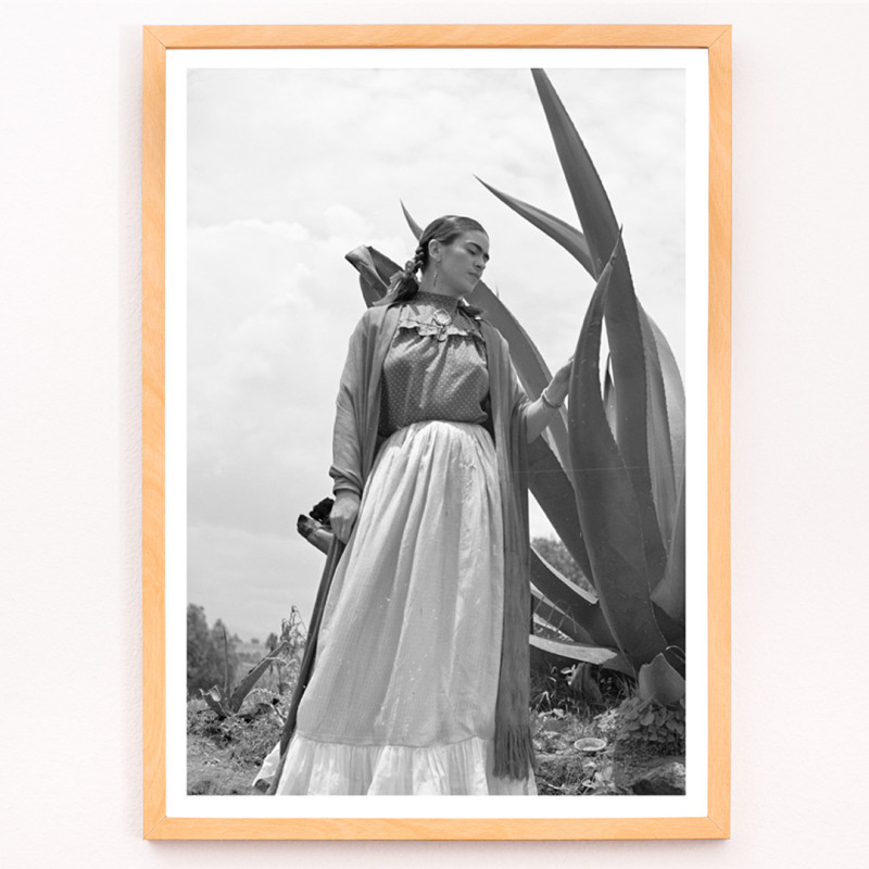 Frida Kahlo in piedi accanto a una pianta di agave