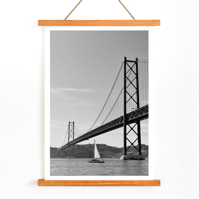 Poster featuring Lisbon Bridge Black & White Picture with a framed photograph of a suspension bridge and a sailboat in the water