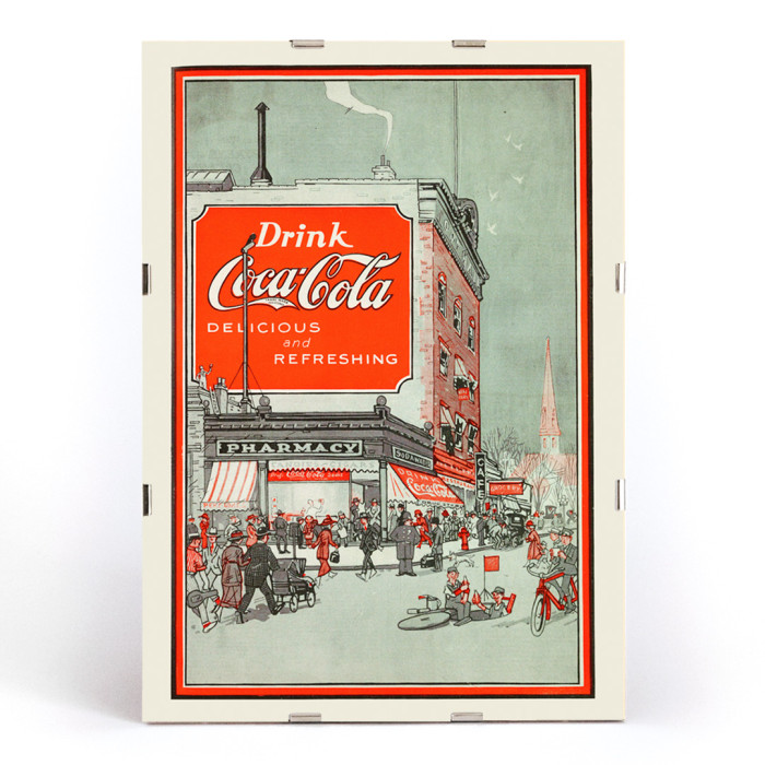 Poster titled Drink Coca Cola showing a bustling street scene with people near a pharmacy and a large Coca Cola billboard