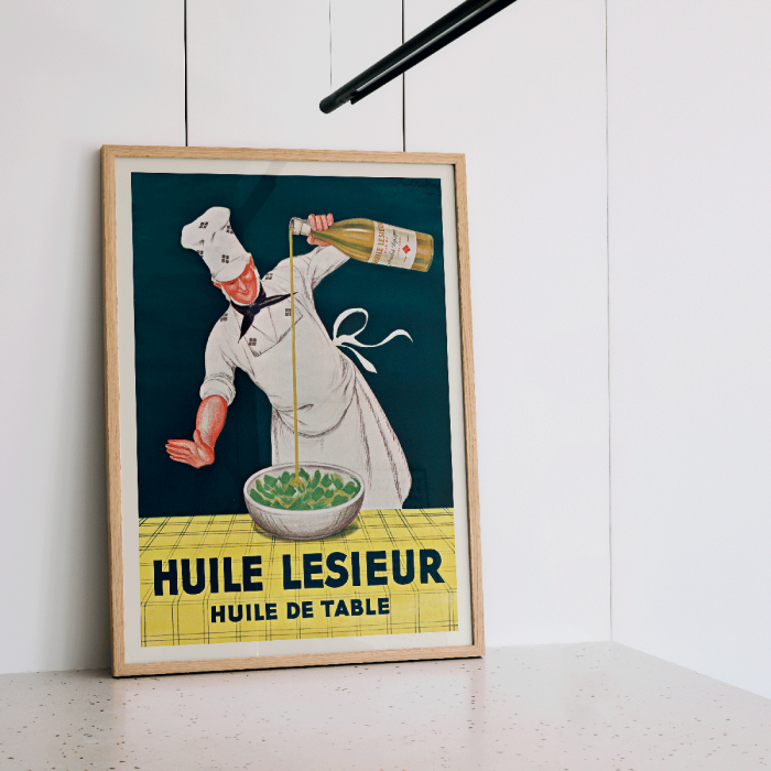 Poster featuring a chef pouring oil from a bottle into a bowl of salad Huile Lesieur by Leonetto Cappiello.