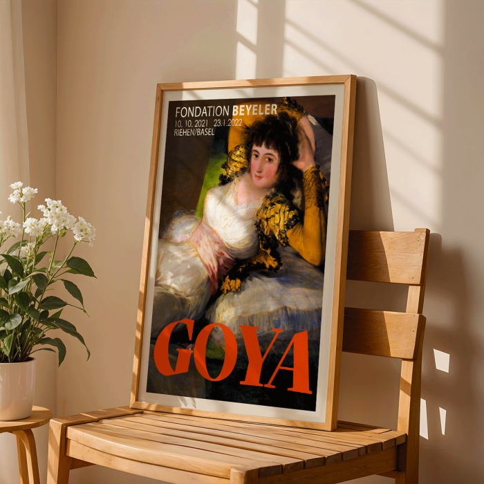 Cartel de la exposición La maja vestida de Francisco Goya en la Fundación Beyeler que muestra a la mujer reclinada con un atuendo blanco y dorado